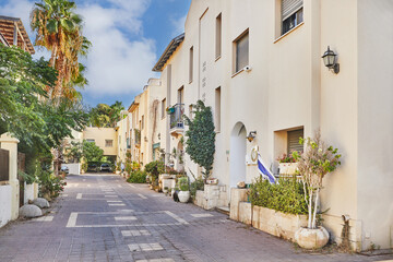 Fototapeta na wymiar Nice Israeli courtyard with Mediterranean-style residential buildings