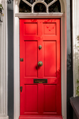Obraz na płótnie Canvas Bright red front door, minimalist design.