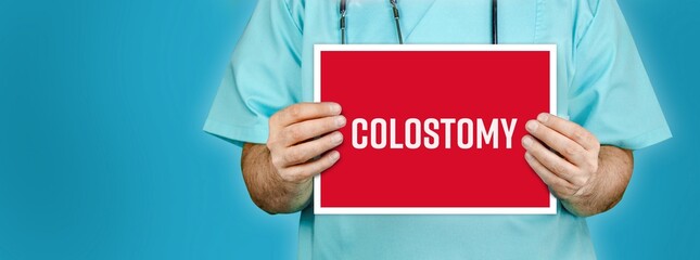 Colostomy. Doctor shows red sign with medical word on it. Blue background.