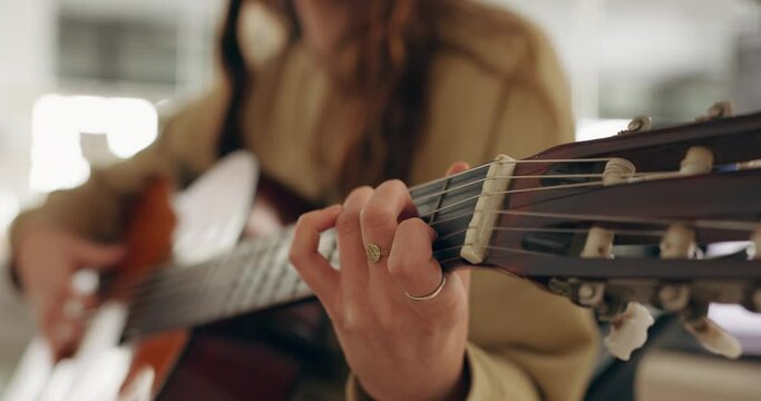 Hands, music and guitar by woman artist playing a song in a studio, live and closeup acoustic performance. Guitarist, female and hippie musician performing musical instrument for rock or metal track