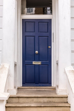 Front door, blue front door, white exterior of a house