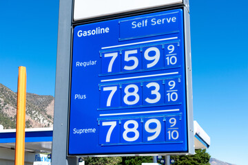 Gas station price sign showing record high gasoline prices for over 7 dollars a gallon of regular...