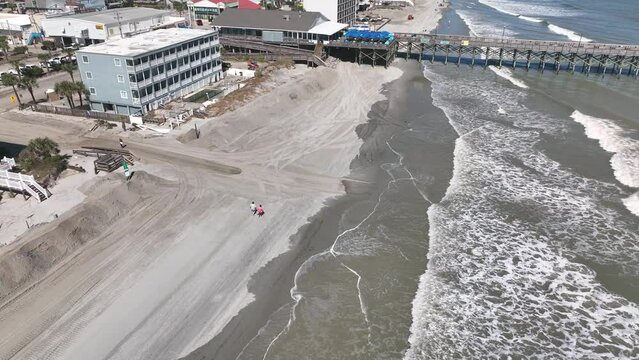 Clean up after Hurricane Ian storm surge causes beach erosion and damages property at Surfside Garden City along coastal South Carolina