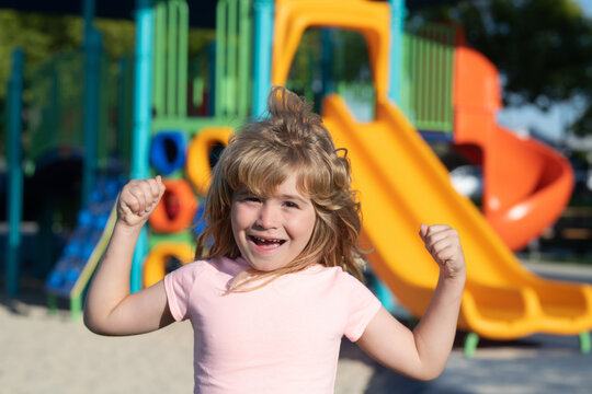 Child playing on outdoor playground. Kids play on school or kindergarten yard. Healthy summer activity for children.