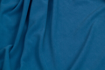 Fleece fabric blue top view. Texture of textile fleece bedspread.