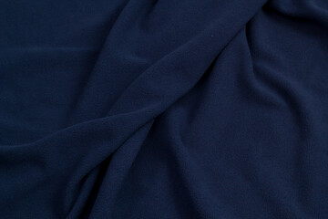 Fleece fabric blue top view. Texture of textile fleece bedspread.
