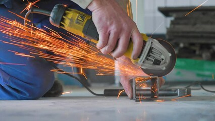Man cutting metal with circular saw. Spark from hot iron. Hands and electric saw, hand tool. Hard work.