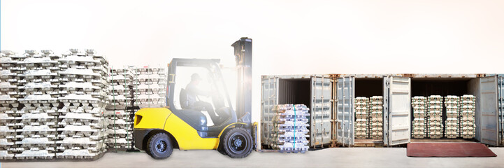 Forklift stuffing aluminum ingot into container. Aluminum ingot handling and transportation for import and export. Warehouse equipment operation, logistics, and transportation. 