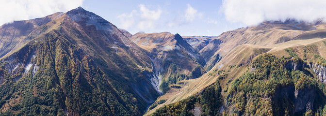 Mountain landscape panorama. Waterfall on a mountain river at the bottom of the gorge.