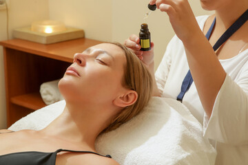 Obraz na płótnie Canvas Face massage, a woman in the spa having anti-age face massage