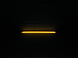 Yellow neon light from the lamp in a dark room