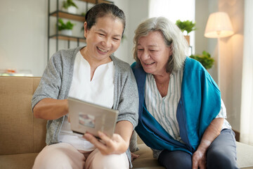 Woman Showing Photo Album to Friend