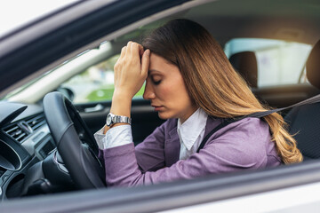 Businesswoman having headache has to make a stop after driving car in traffic jam