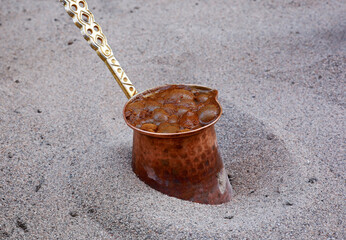 Naklejka premium Turkish coffee cooked in an antique copper pot