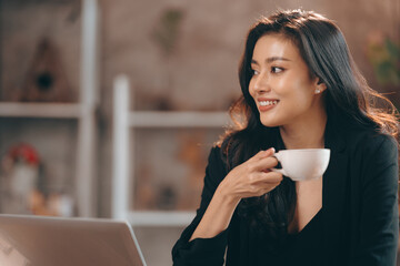 young business freelance woman lifestyle with online work communication job in cafes, businesswoman entrepreneur holding hot drink coffee cup by using laptop computer on cyberspace modern technology