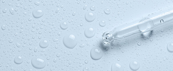Micellar water drops and pipette. Cosmetic product for moisturizing the skin or removing makeup. Close-up, macro photography