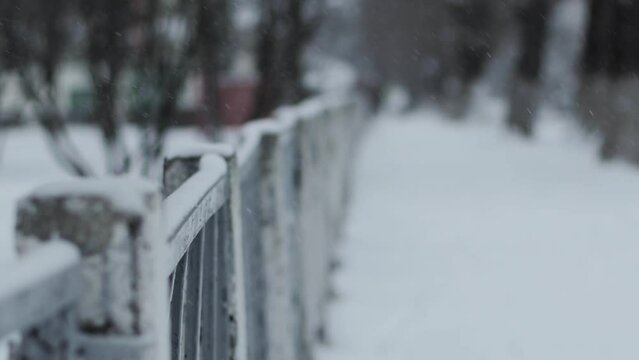 Protective fence with a metal mesh netting against the background of snow in winter, windstorm. Copy space for text