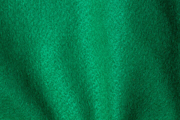 Green hue color felt textile fabric texture background. Abstract geometric wave background