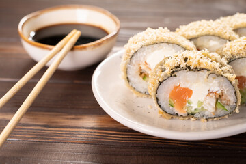 Hot fried sushi roll with salmon, avocado and cheese philadelphia. Sushi menu. Japanese food.