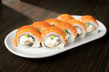 Philadelphia roll sushi with salmon, smoked eel, avocado, cream cheese. Sushi menu. Japanese food.