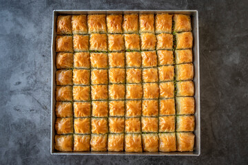 Pistachio baklava. Tray baklava on dark background. Traditional Turkish cuisine delicacies. close up