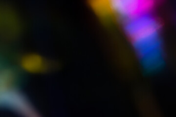Blur colorful rainbow crystal light leaks on black background. Defocused abstract multicolored retro film lens flare bokeh analog photo overlay or screen filter effect. Glow Vintage prism colors