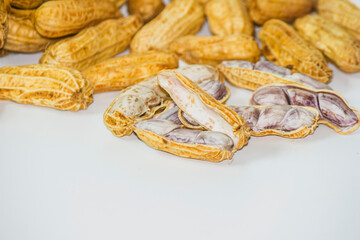  Boiled peanuts, shelled and seeds inside on a white background.