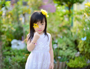 backlight Outdoor portrait of a cute 5 year old Asia little girl 