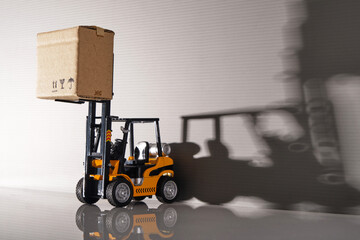 close up of toy forklift with cardboard box