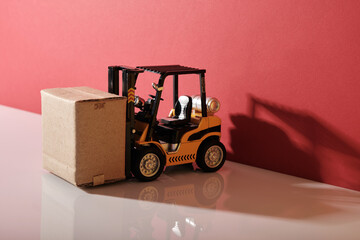 close up of toy forklift with cardboard box