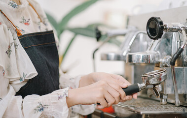Opening a small business, AHappy Asian woman in an apron standing near a bar counter coffee shop, Small business owner, restaurant, barista, cafe, Online, SME, entrepreneur, and seller concept