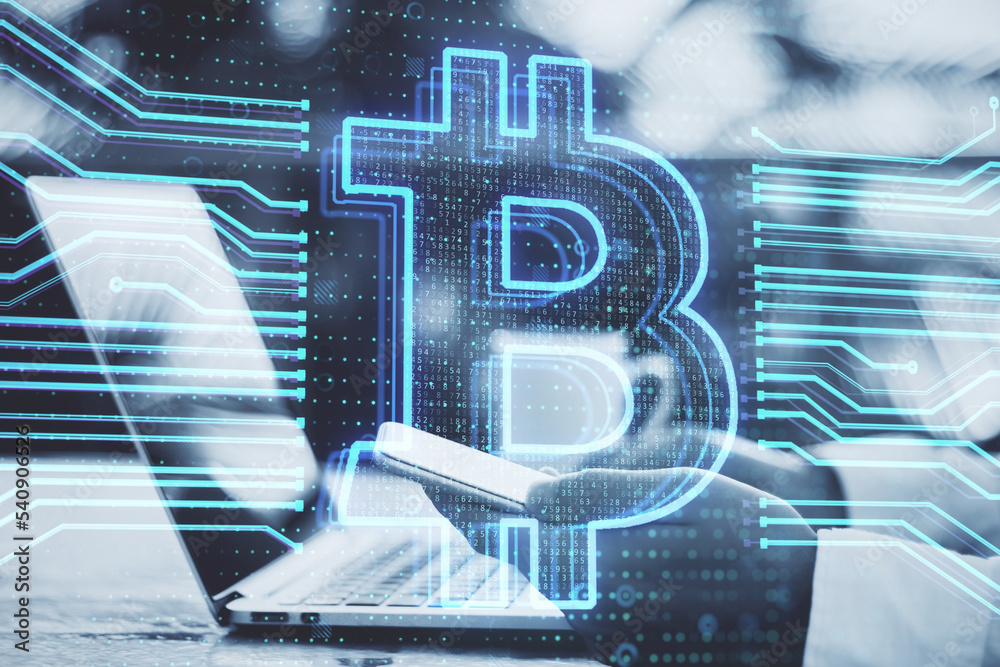 Poster Close up of hand using laptop keyboard and smartphone with creative bitcoin hologram on blurry desktop with coffee cup background. Cryptocurrency and blockchain concept. Double exposure.