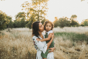 Motherhood portrait with her daughter outdoors 