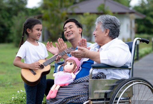 A young man takes a young girl to visit an elderly woman at a nursing home.