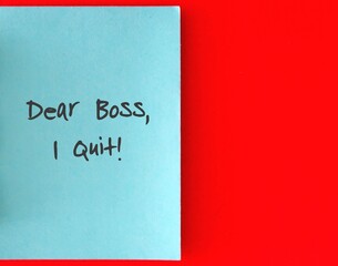 Blue note card with text written DEAR BOSS I QUIT on red paper for copy space - Concept of decision making to quit job, resign from full time corporate job, leave horrible boss or workplace
