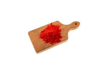Dried Red Chili Pepper or Paprika powder on wooden cutting board on white background. Red pepper ground, hot spices - Powered by Adobe