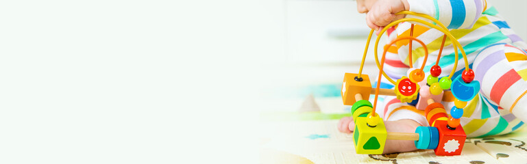 Obraz premium Baby plays with an educational toy. Selective focus.