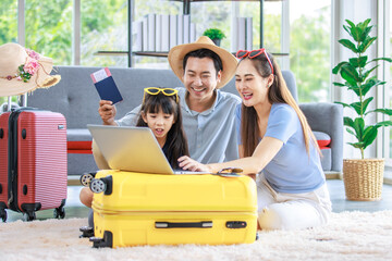 Millennial Asian lovely happy family father mother and young little girl daughter helping packing...