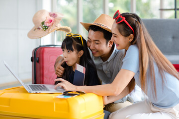 Millennial Asian lovely happy family father mother and young little girl daughter helping packing...