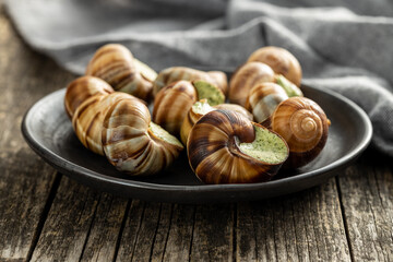 Snails with parsley butter, Bourgogne Escargot Snails on plate. Delikatese food.