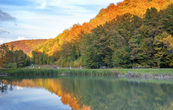 Autumn in the mountains near the lake. Beautiful reflection in the water.