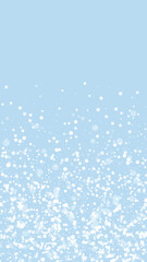 Fototapeta na wymiar Beautiful snowfall christmas background. Subtle flying snow flakes and stars on light blue winter backdrop. Beautiful snowfall overlay template. Vertical vector illustration.
