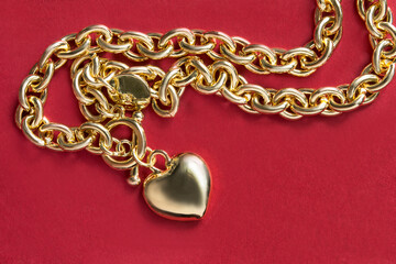 Gold necklace on red background