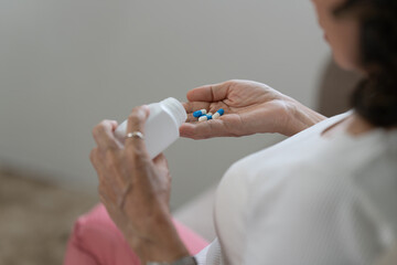 Elderly Asian Woman taking pill at home. Age, Medicine, Healthcare and People concept.