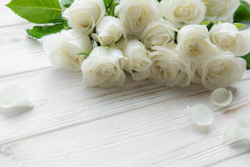 White roses on a wooden table