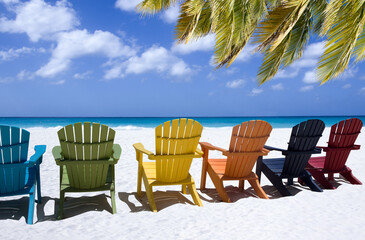 Colored beach chairs on white sand 