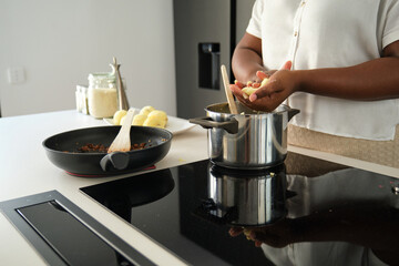Close up of cuban woman hands moulding mashed potatoes into a ball to prepare cuban style stuffed potatoes.