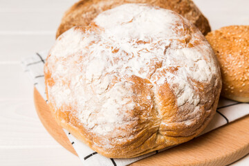 Homemade natural breads. Different kinds of fresh bread as background, perspective view with copy space