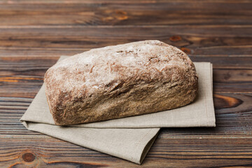 Assortment of freshly baked bread with napkin on rustic table top view. Healthy unleavened bread. French bread