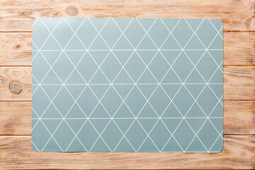Top view of grey tablecloth for food on wooden background. Empty space for your design